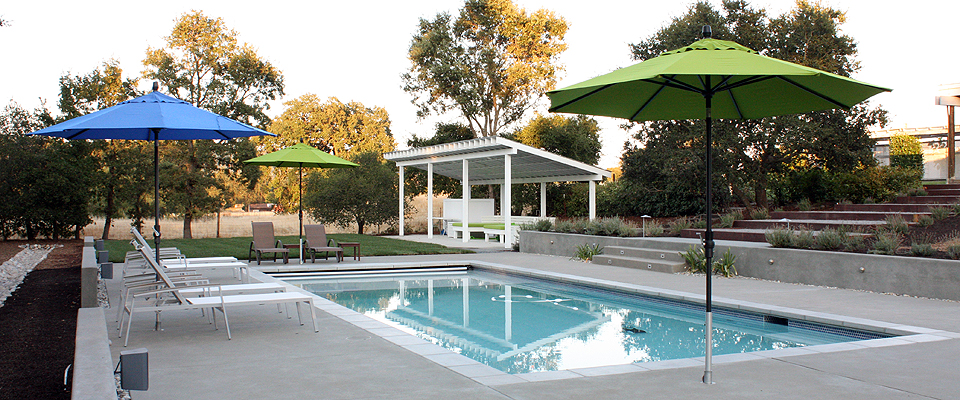 Sonoma Landscape Pool with Green and Blue Umbrellas, Shade Structure, Chaise Lounges, Golden Hour