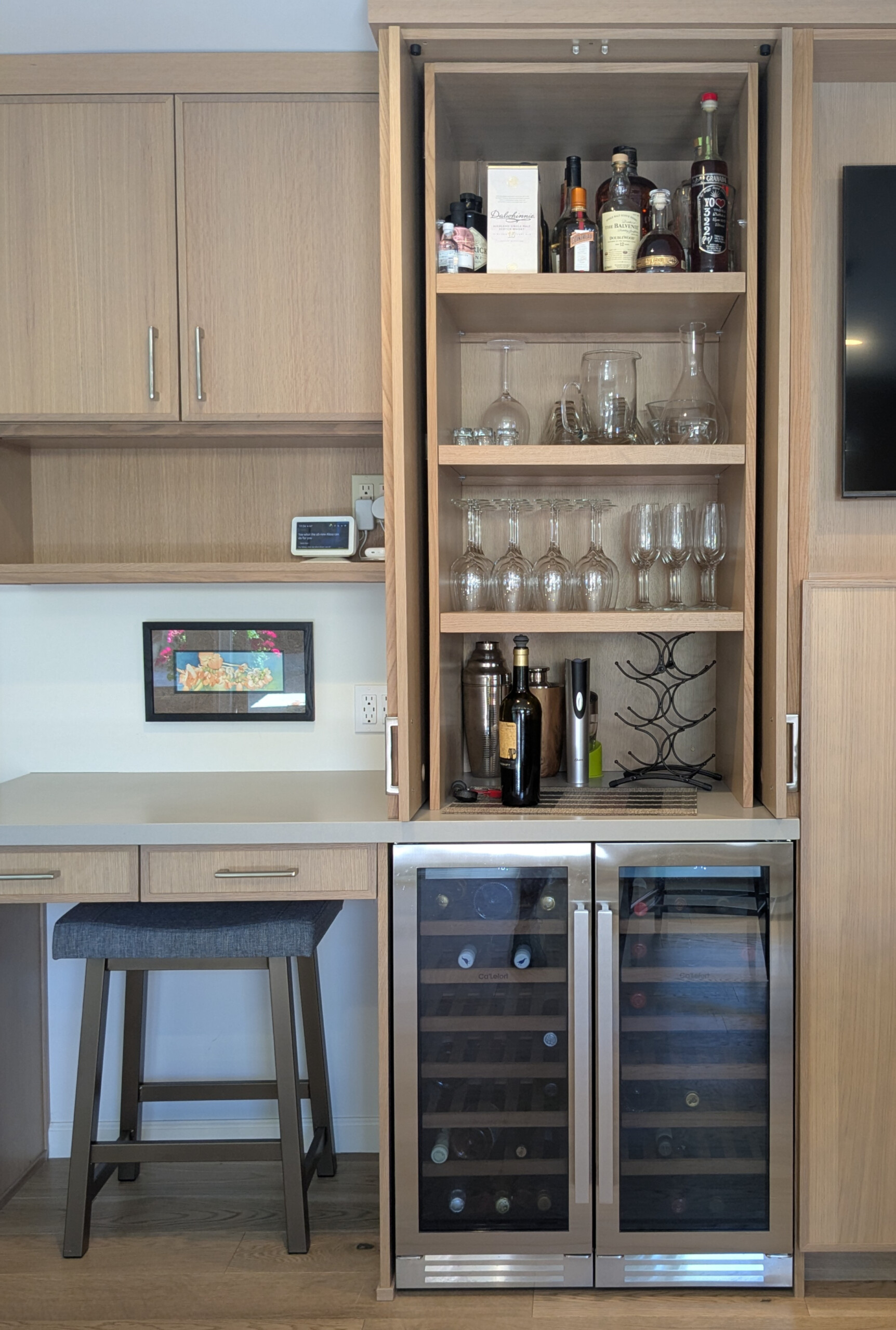 Cabinetry with glasses, wine rack and work area