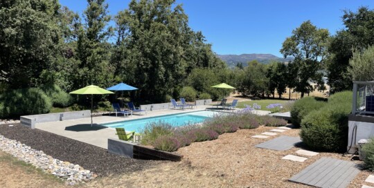 View of a Pool, Chaise Lounges and the Mayacamas Mountains