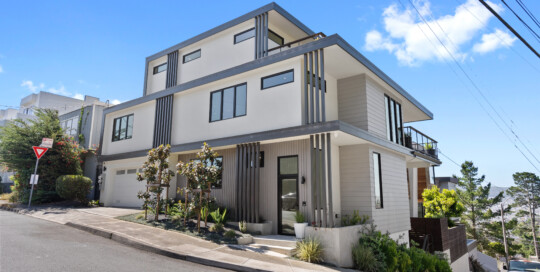 A white home with mid modern exterior brown details