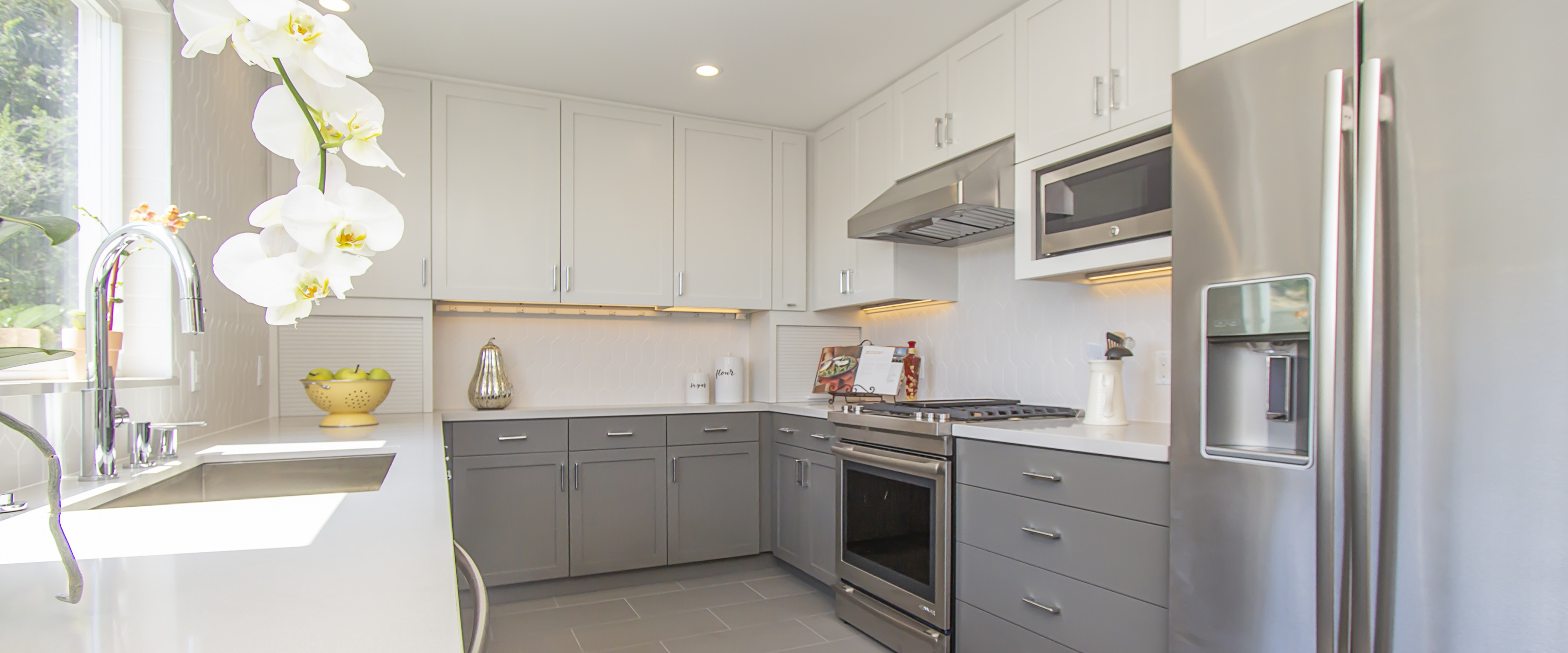 Kitchen with a perfect work triangle, custom cabinetry, Caesarstone counters, and picket-fence tiles from Sonomatilemakers